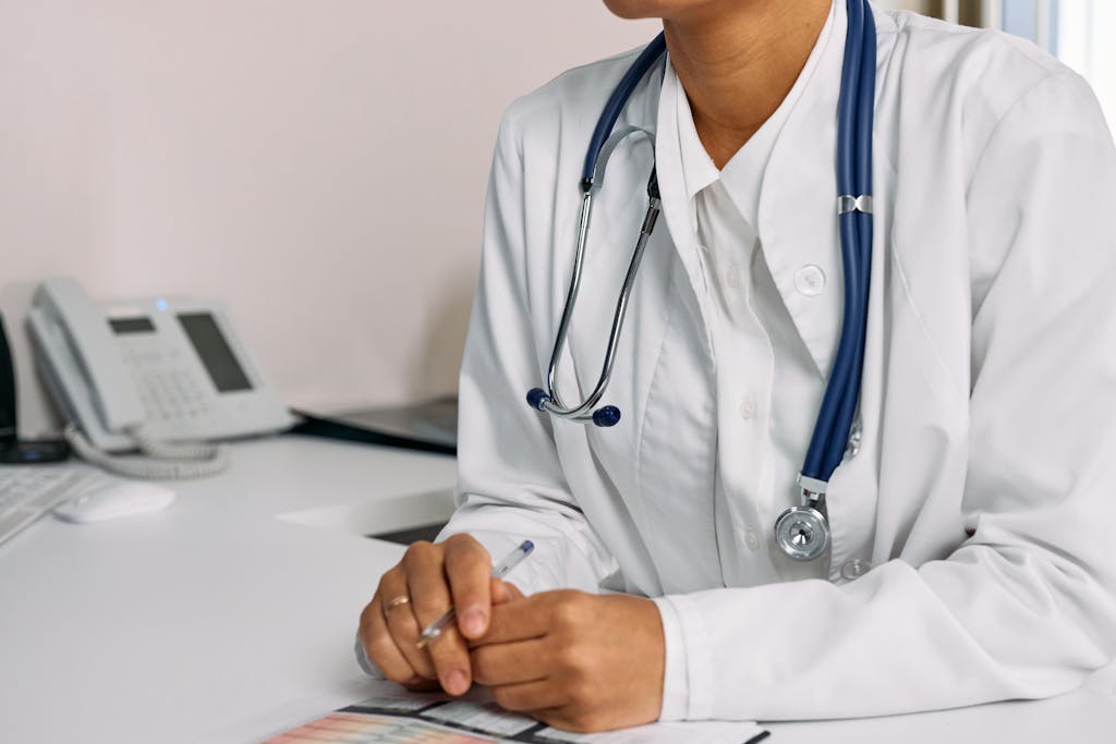 A Woman in White Coat Sitting at the table